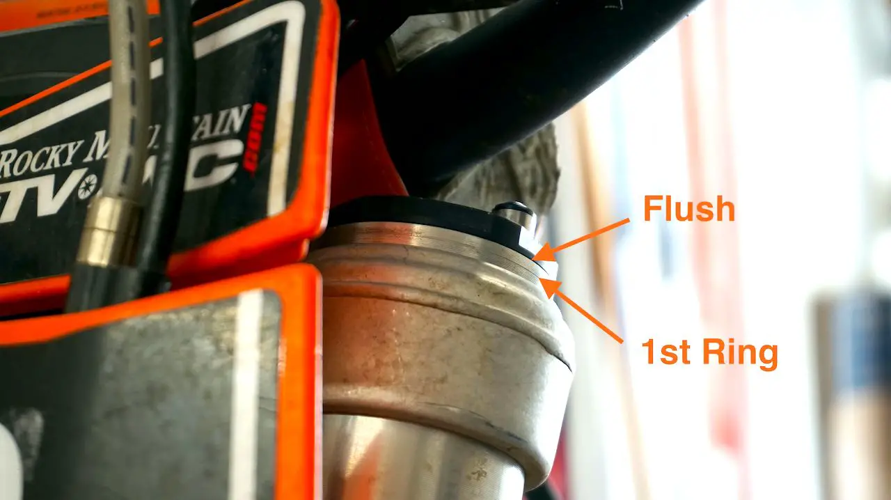 Top of the front fork of a dirt bike after adjusting front fork height to second ring setting