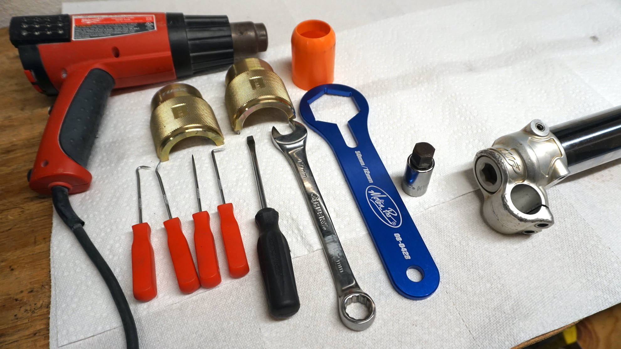 Recommended tools for rebuilding dirt bike forks laid on the table