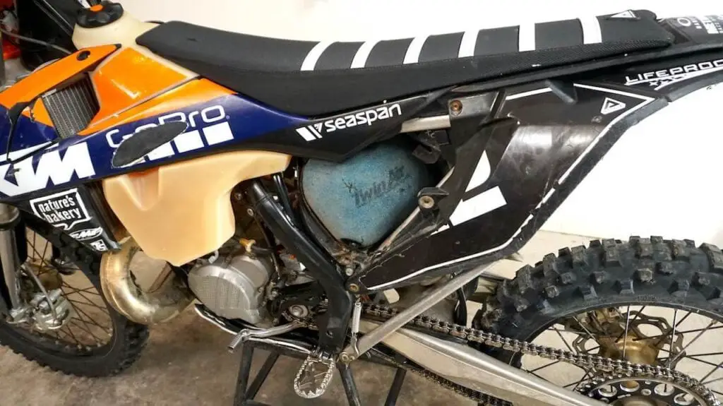 Left side of a dirt bike showing the clean dirt bike air filter installed in the air box