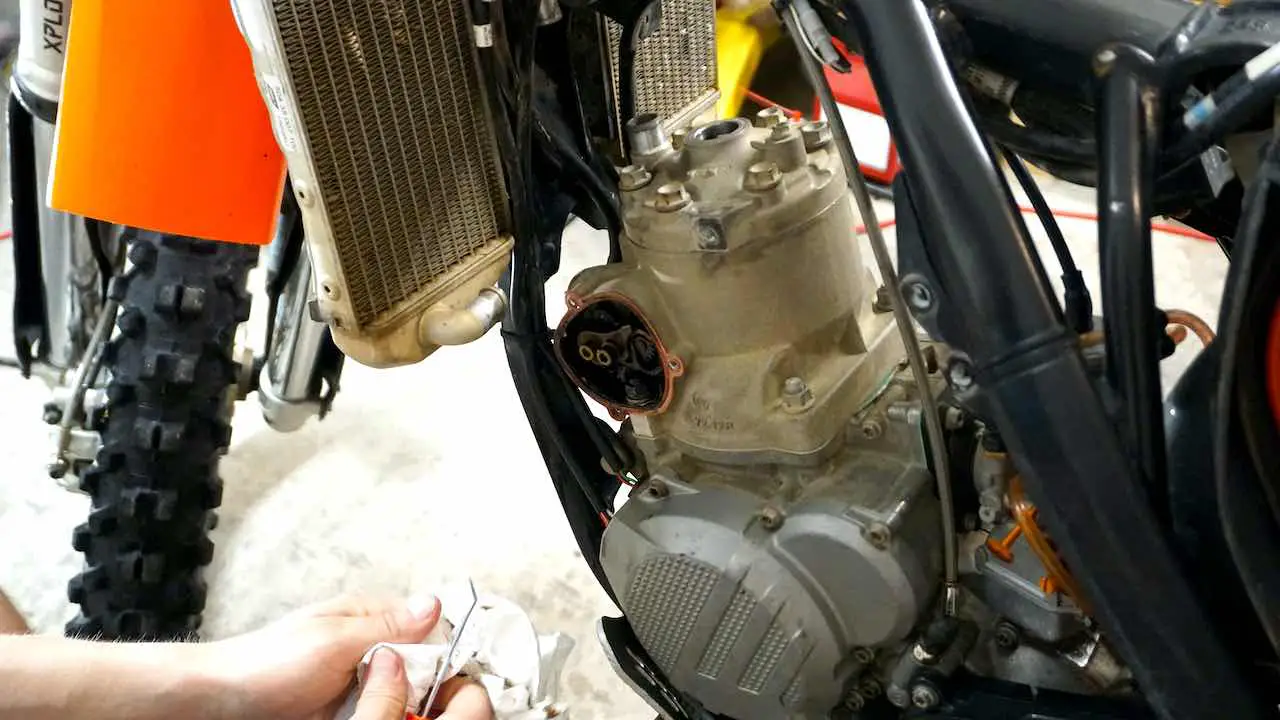 A dirt bike cylinder with the left side power valve cover removed
