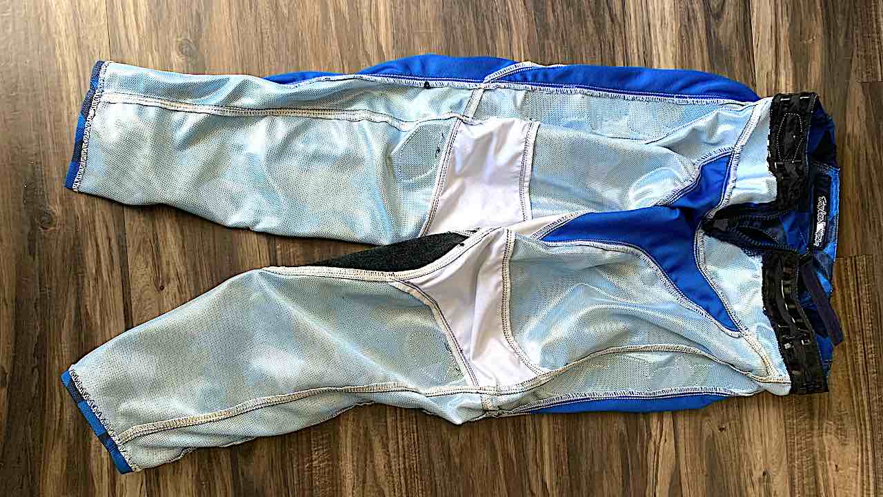 Dirt bike pants with mesh inner liner is cut off
