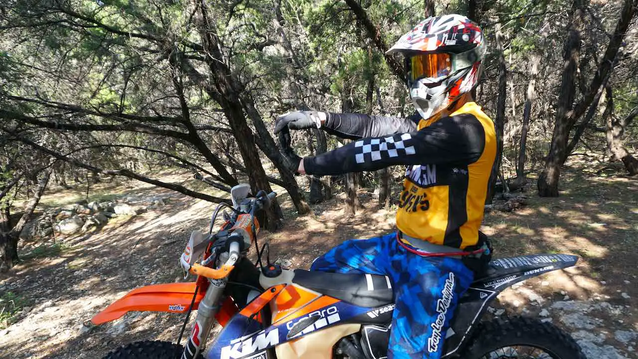 Dirt bike rider stretching hands to prevent carpal tunnel