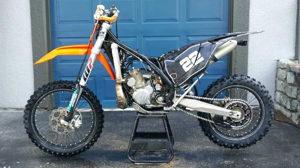 Dirt bike with dirt bike gas tank removed on a center stand