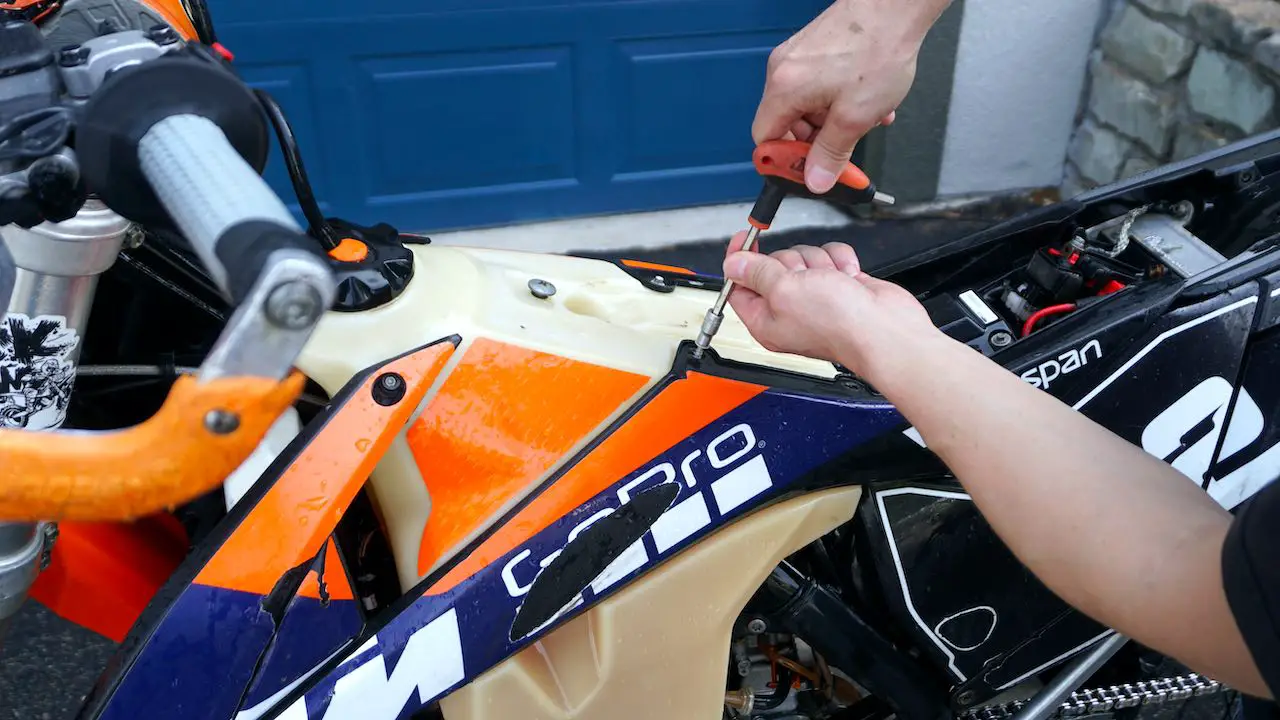 Removing bolts from the plastics on a dirt bike
