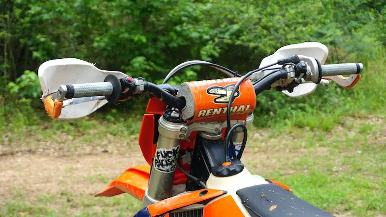 Handguards installed on a dirt bike to improve cornering around trees