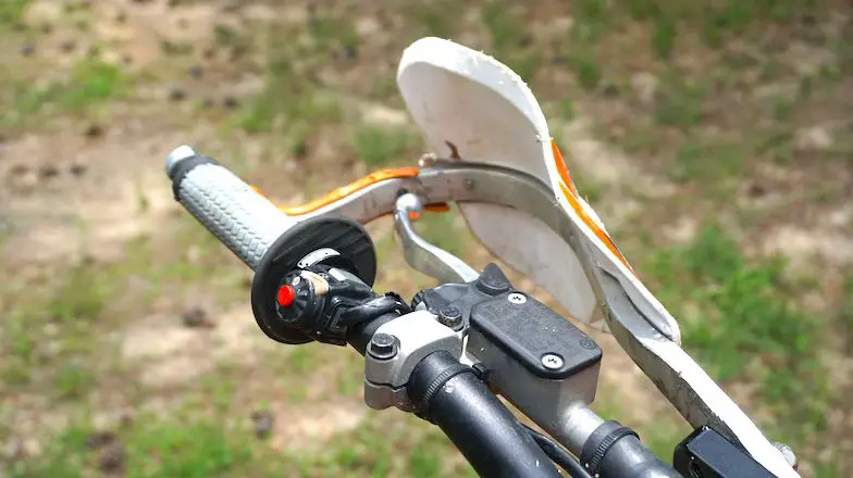 Dirt bike left grip positioned to the end of the handlebar