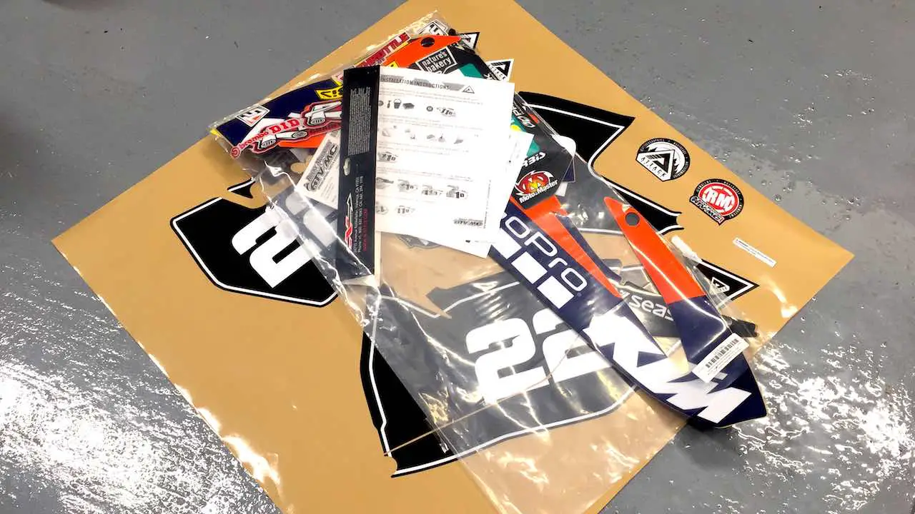 New dirt bike graphics set on the floor ready to be installed