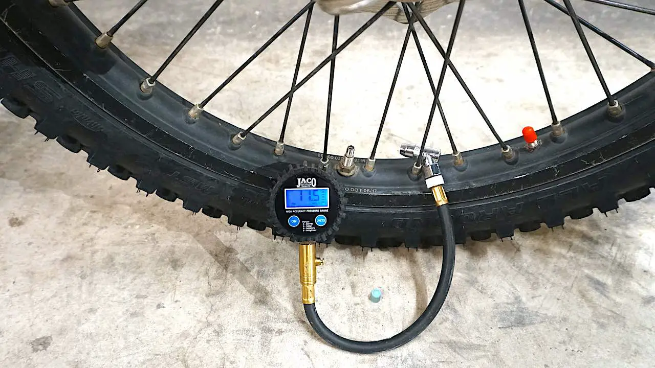 Dirt bike front tire inflated to 11.5 PSI for trail riding
