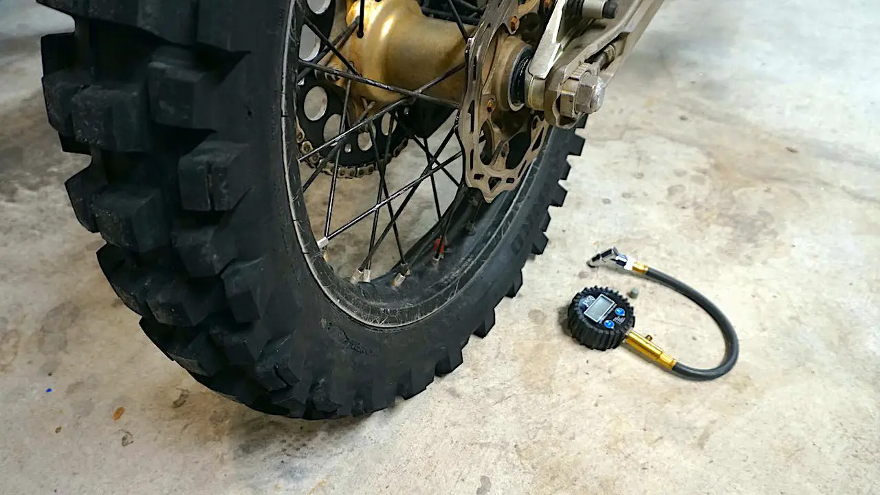 Dirt bike rear tire almost flat against the ground for maximum traction