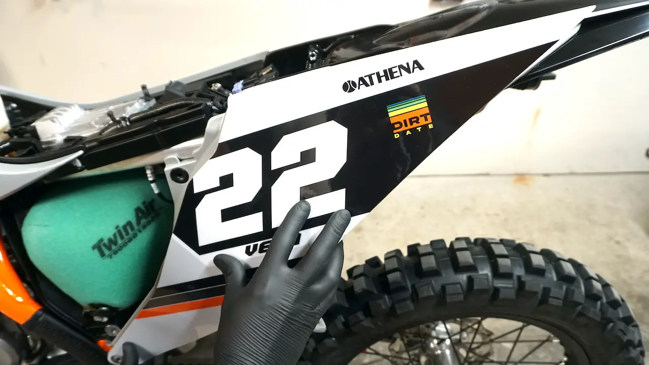 Test fitting new graphics on a dirt bike side panel