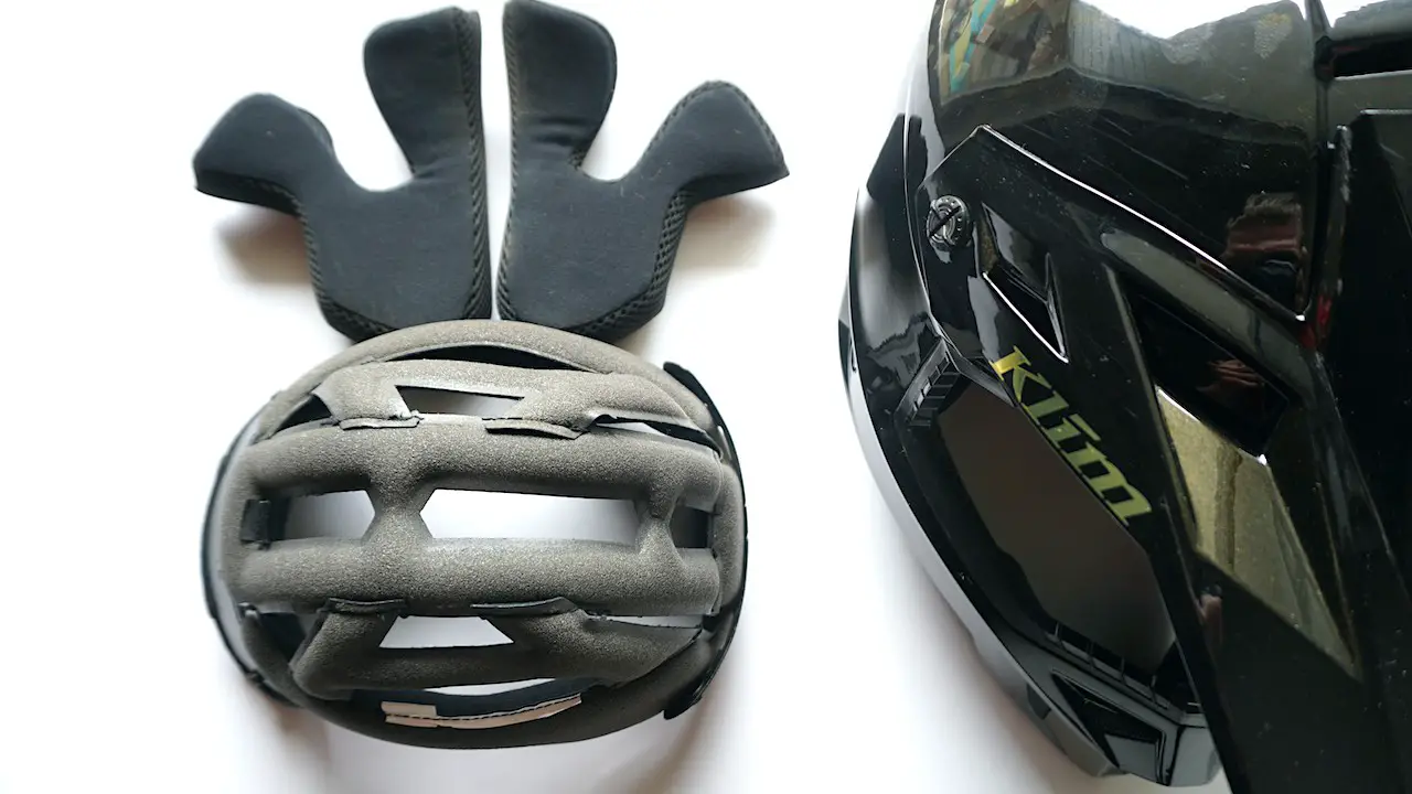 The helmet inner liner taken off the helmet and laid on the table.